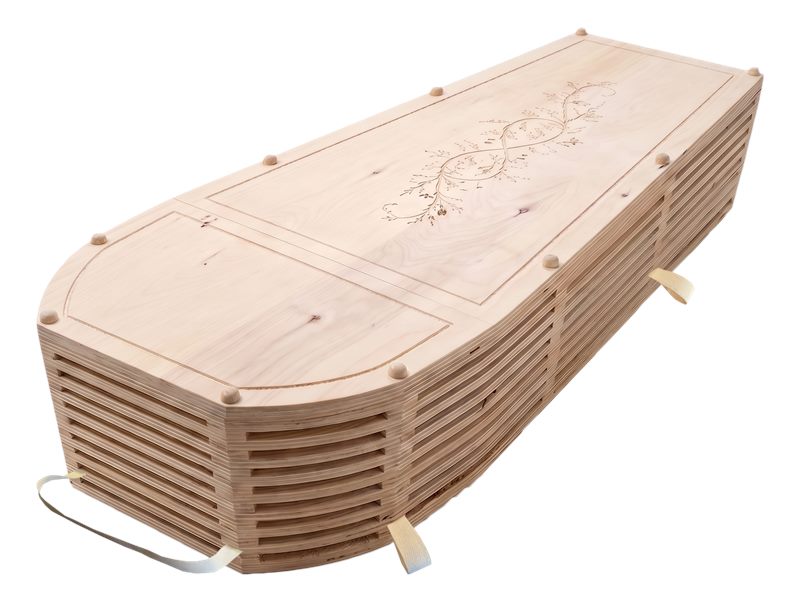 The Cypress green burial coffin in light natural wood with slatted sides and a carved botanical motif on the lid