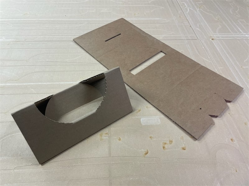 Folding headblock in die-cut corrugated board, shown both flat and assembled