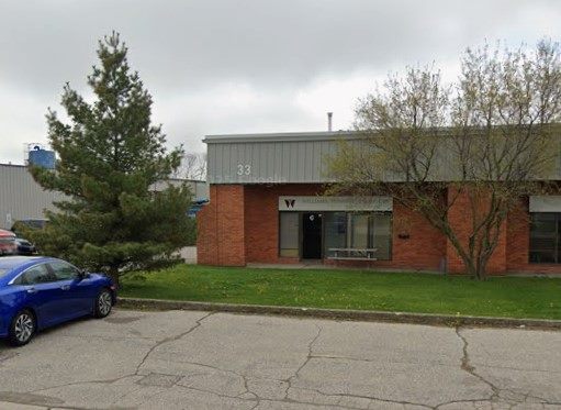 The Williams Funeral Products premises at 33 Worthington Drive in Brantford, a low brick and steel unit with the company sign beside the entrance