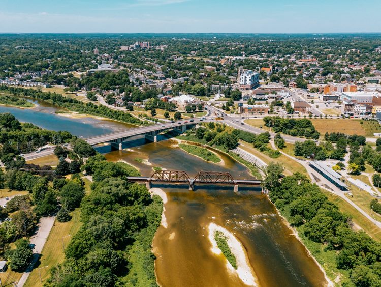 An aerial view of Brantford, Ontario, with the Lorne Bridge and the rail bridge crossing the Grand River